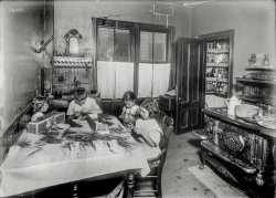August 1912. Roxbury, Mass. "Home work on tags. Home of Martin Gibbons, 268 Centre Street. James 11, years old; Helen, 9 years; and Mary, 6, work on tags. Helen said she could tie the most (5,000 a day at 30 cents). Mary does some but can do only 1,000 a day. They work nights a good deal. The night before, Helen and James worked until 11 p.m." Photo by Lewis Wickes Hine. View full size.