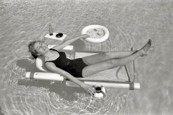 April 1961. "Sunbathing with the latest swimming pool equipment, including a lounge chair with floating beverage holders and game table attachments." From photos by Bob Sandberg for the Look magazine assignment "For Women Only -- Pool Life." Tell your kids about how back in the day people couldn't play cards or smoke in the pool, and all you're likely to get is a blank stare. View full size.