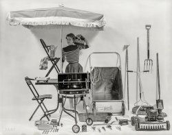 1954. "Backyard Rooms. Woman posed with yard equipment, outdoor furniture, appliances and utensils used to cook outdoors. Equipment shown includes power lawn mower, lawn sweeper, grill, patio table and umbrella, and portable radio." Medium-format negative by Arthur Rothstein for the Look magazine assignment "How to Build an Extra Room in Your Own Backyard." View full size.