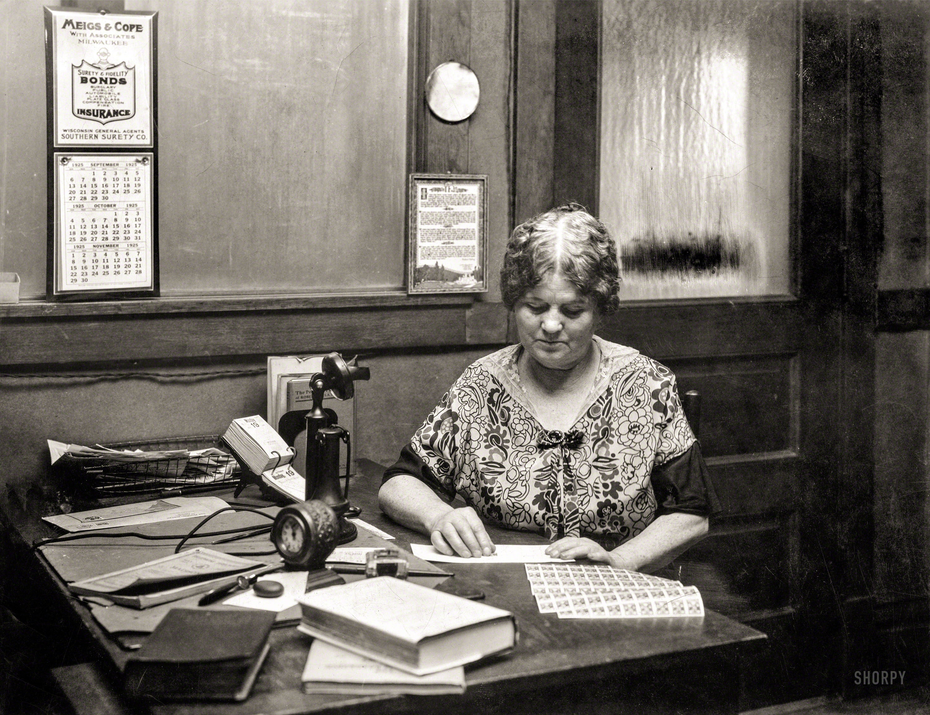 There's no caption for this yellowing print of a lady at an office desk with postage stamps (quite possibly on October 19, 1925). Yet there must be some reason it's in the Library of Congress Prints & Photographs Online Catalog. View full size.