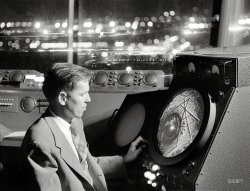 September 1952. "Man in an airport control tower looking at radar screen." From photos by Phillip Harrington for the Look magazine assignment "International Airport." Who'll be first to locate this anonymous airfield? View full size.