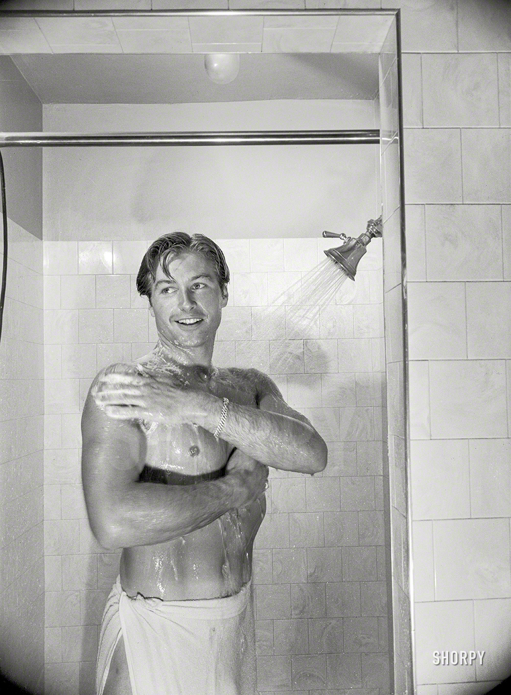 Los Angeles, 1948. "Shower ends Lex's non-acting day that includes lifting weights, punching bag and many other exercises." From photos by Maurice Terrell for the Look magazine assignment "Lex Barker: Princeton-Bred Tarzan." View full size.