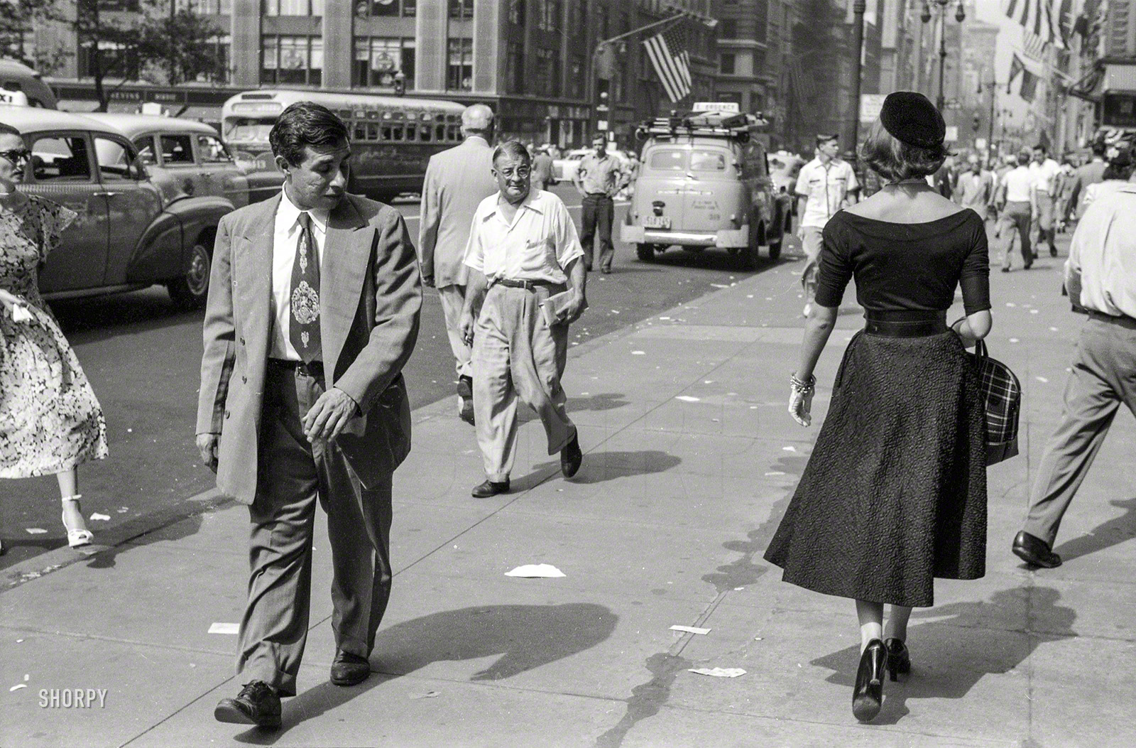 New York, September 1952. "People looking at fashion model Doris Erwin as she walks down Fifth Avenue." From photos by Ralph Ginzburg for the Look magazine assignment "A Young Man's Fancy -- Model on the Street." View full size.