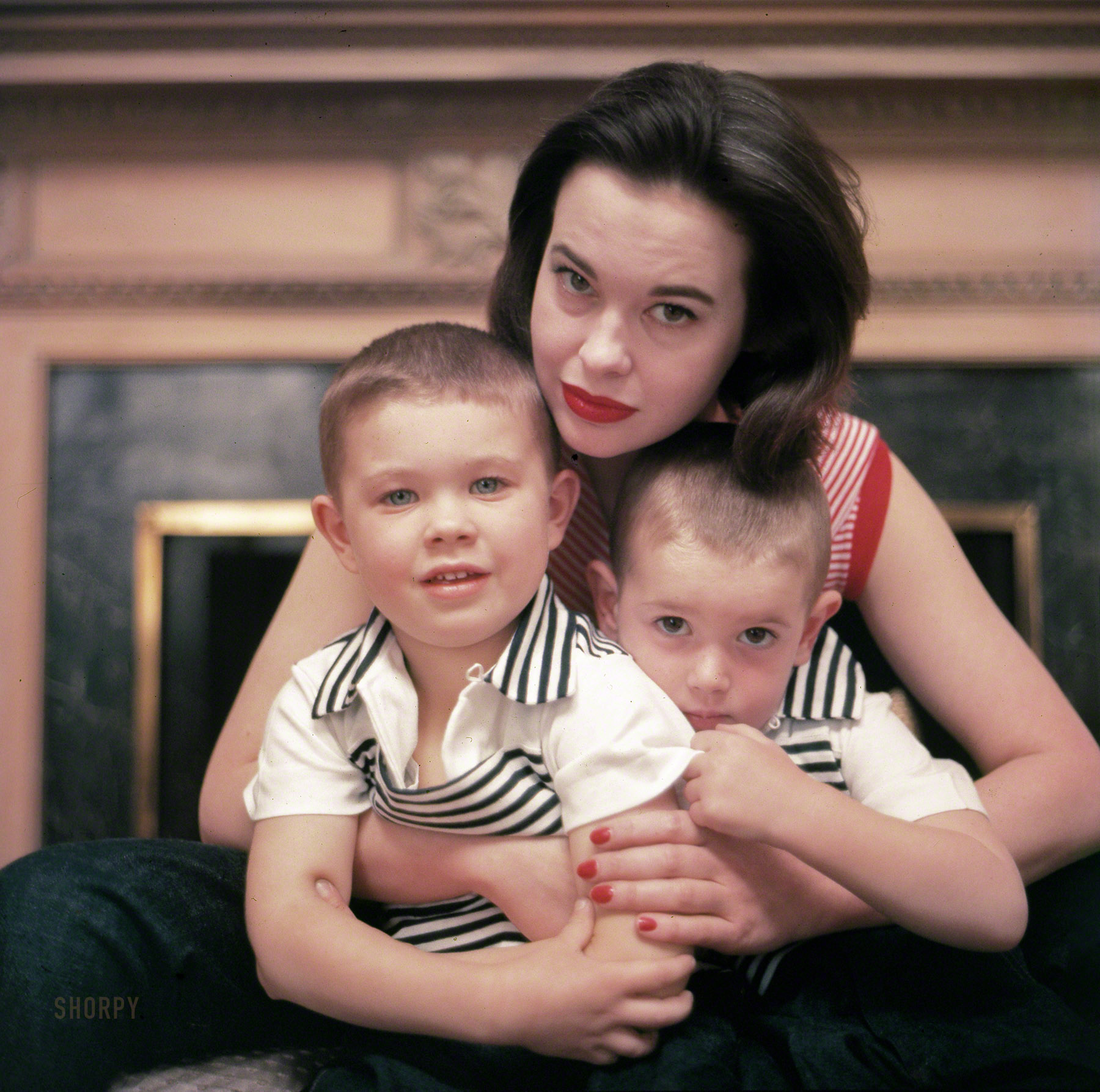 &nbsp; &nbsp; &nbsp; &nbsp; Gloria Vanderbilt, the society heiress who stitched her illustrious family name into designer jeans and built a $100 million fashion empire, crowning her tabloid story of a child-custody fight, of broken marriages and of jet-set romances, died on Monday at her home in Manhattan. She was 95.
— New York Times
January 1955. "Socialite Gloria Vanderbilt in her New York City apartment with Stanislas and Christopher, her sons by conductor husband Leopold Stokowski." Color transparency from photos for the Look magazine assignment "Gloria Vanderbilt Builds a New Life." View full size.