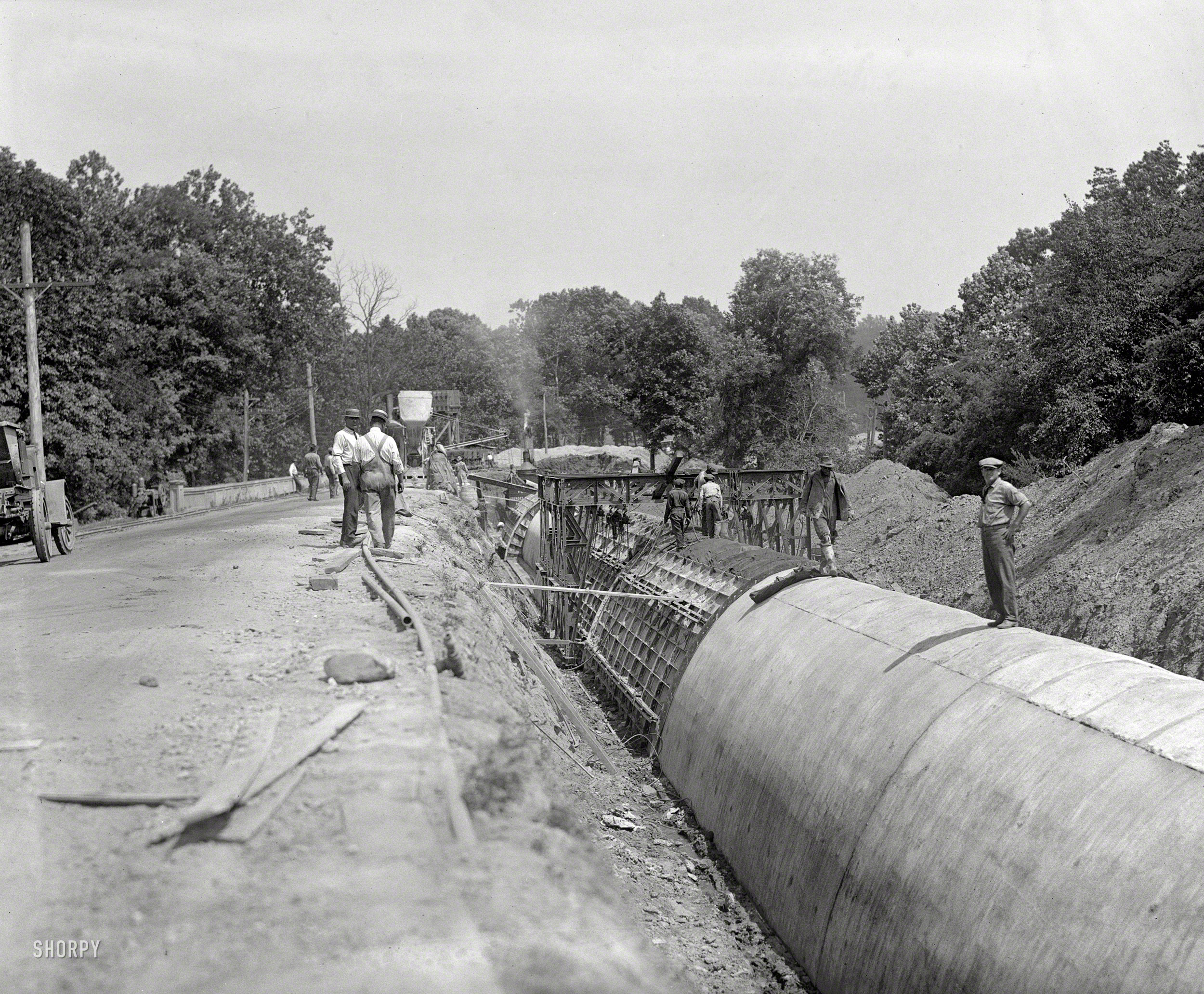 July 21, 1923. "Water conduit." Part of the Washington, D.C., aqueduct system seen here, along what used to be called Conduit Road. View full size.