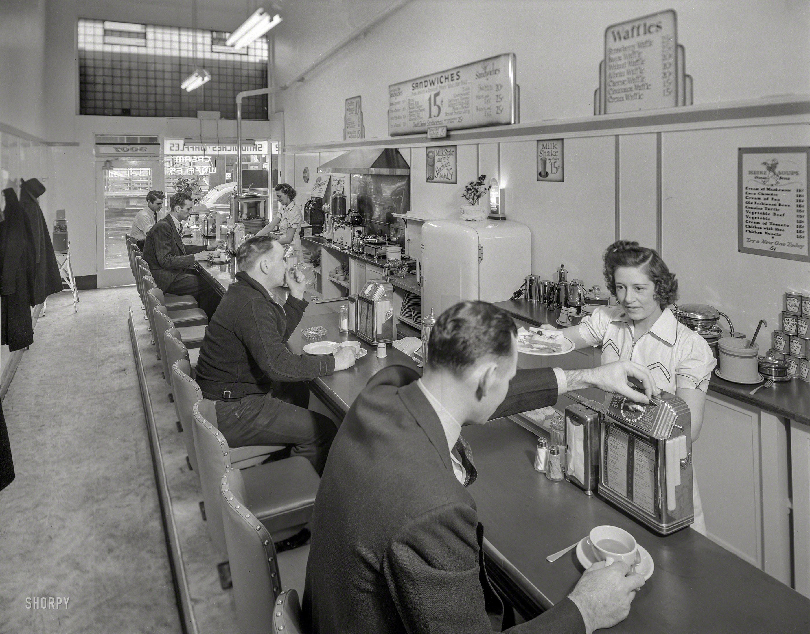 &nbsp; &nbsp; &nbsp; &nbsp; UPDATE: Restaurant ID courtesy of Sagitta.
San Francisco circa 1941. "Restaurant counter." And another shot of the Buckley Music System "Music Box." (Selection No. 1: "Three at a Table for Two" by Dick Todd.) 8x10 acetate negative, photographer unknown. View full size.