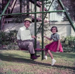 November 1953. Beverly Hills, California. "Comedian Groucho Marx sitting on a swingset with daughter Melinda." Ektachrome transparency from photos for the Look magazine assignment "Hollywood Fathers." View full size.