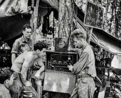 November 12, 1942. "Jap radio tuned in on U.S. --  Marine communicators found this radio set which was left behind by the Japs on Guadalcanal, and use it to listen in on U.S. broadcasts in their leisure time. The Marines are (left to right) Cpl. James Shadduck, Pvt. Alex N. Incinelli, Pvt. Robert Galer, Cpl. Sidney B. Land and Pvt. Arthur D. Roda, and part of their job is to see that the messages get through." New York World-Telegram & Sun newsphoto. View full size.