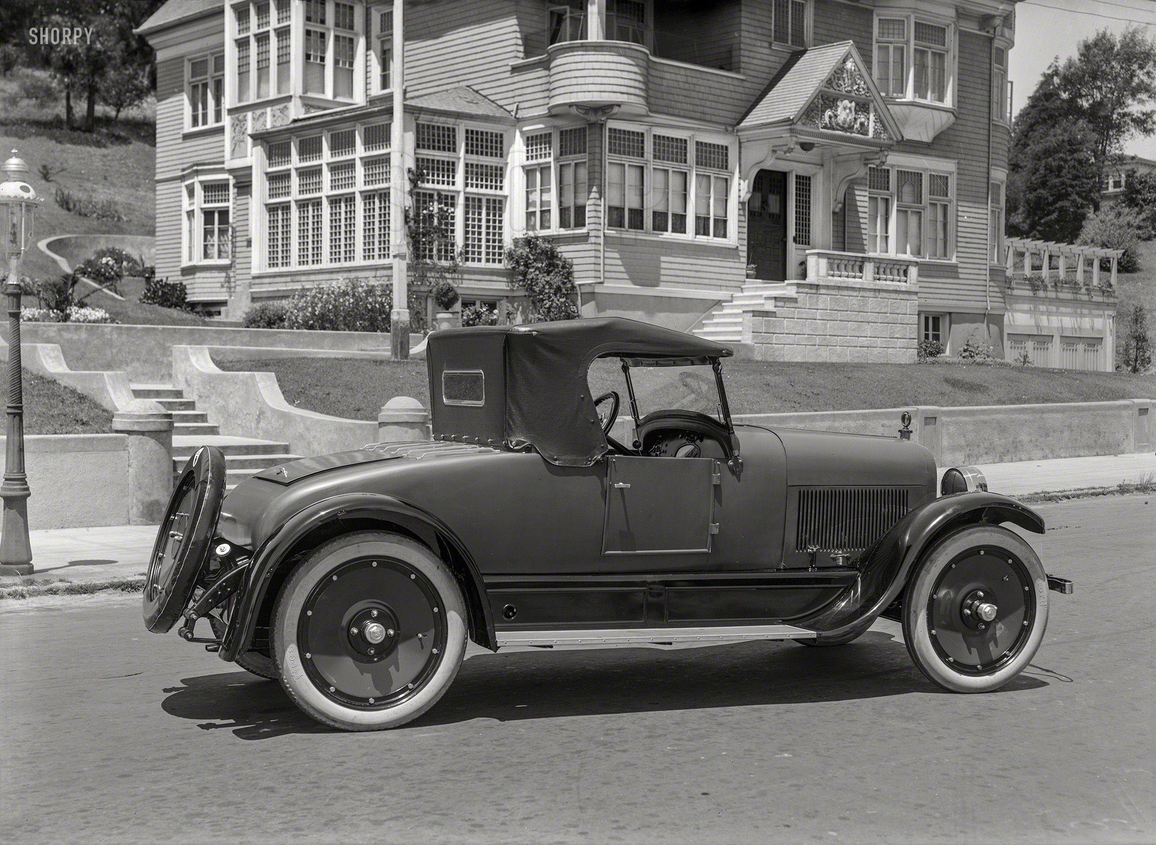 San Francisco circa 1923. "Jordan Playboy roadster." A car famous for the ad copy that sold it. 5x7 glass negative by Christopher Helin. View full size.
&nbsp; &nbsp; &nbsp; &nbsp; Somewhere west of Laramie there's a broncho-busting, steer-roping girl who knows what I'm talking about. She can tell what a sassy pony, that's a cross between greased lightning and the place where it hits, can do with eleven hundred pounds of steel and action when he's going high, wide and handsome.  The truth is -- the Playboy was built for her. Built for the lass whose face is brown with the sun when the day is done of revel and romp and race. She loves the cross of the wild and the tame.

&nbsp; &nbsp; &nbsp; &nbsp; There’s a savor of links about that car -- of laughter and lilt and light -- a hint of old loves -- and saddle and quirt. It’s a brawny thing -- yet a graceful thing for the sweep o' of the Avenue. Step into the Playboy when the hour grows dull with things dead and stale. Then start for the land of real living with the spirit of the lass who rides, lean and rangy, into the red horizon of a Wyoming twilight.