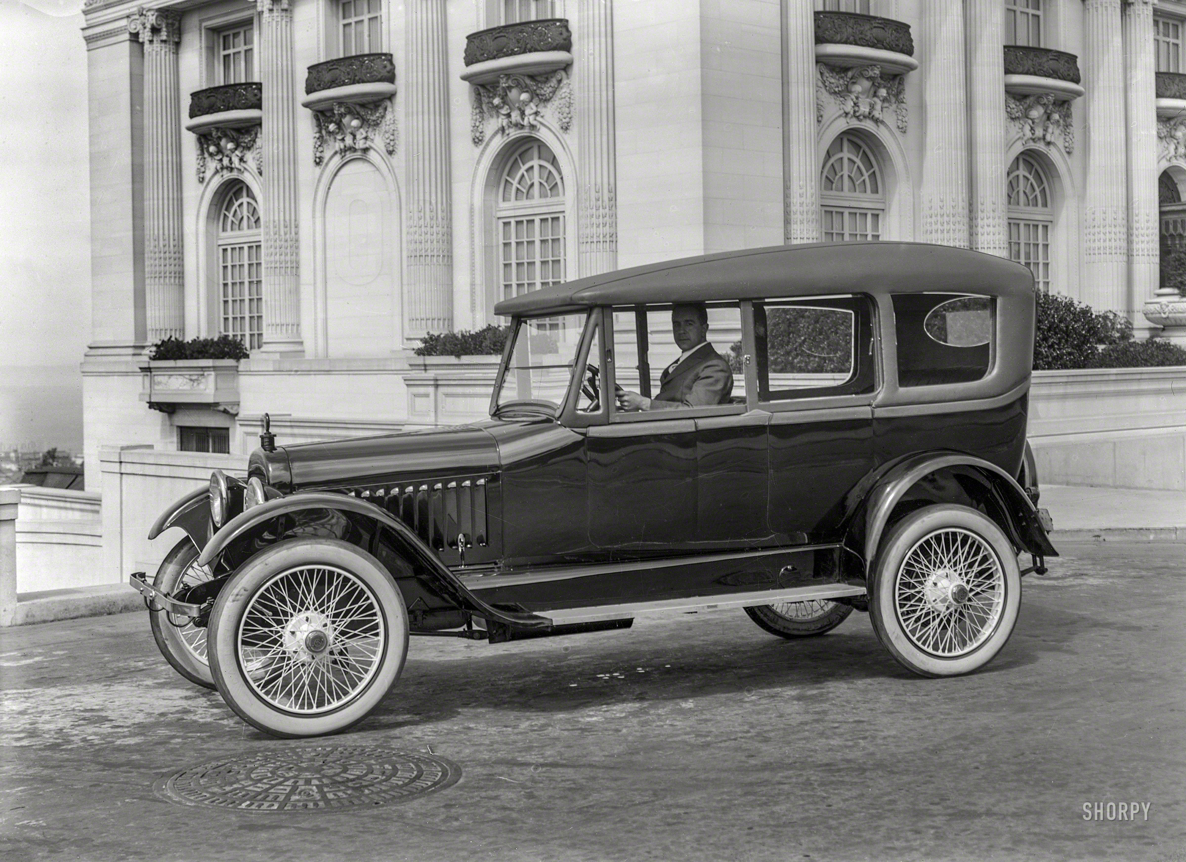 San Francisco circa 1920. "Chalmers touring car at Spreckels Mansion, N.E. corner Octavia & Washington streets." Wearing yet another variation on the "California top," an accessory (this one with sideways-sliding windows) that afforded some of the advantages of the era's heavier, more expensive closed-body models. 5x7 inch glass negative by Christopher Helin. View full size.