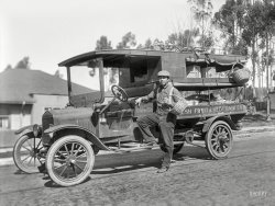 The Bay Area circa 1915. "Chew Sing produce truck." The Fresh Fruit Ford. 8x6 inch glass negative by the Cheney Photo Advertising Company. View full size.
T conversionI think the base Model T for this vehicle is about a 1917 model.  The basic car has been converted to a truck with one of many aftermarket conversion kits available in the day...everything abaft the driver's seat in this rig is aftermarket.  The kit would have involved a rear frame  that lengthened the T's minimalist 100 inch wheelbase and extended forward to support and strengthen the stock frame.  In this one, the stock rear axle drives a chain to the new rear axle and its stouter wheels, dropping the final drive ratio as well.
Not long after this picture was taken, Ford introduced the TT, an extended and lengthened truck based on the T powerplant, as a production vehicle.  General appearance was much like the rig pictured, though it had a worm geared drive at rear axle rather than chains.
Sing had a very neat looking truck!
&quot;Strawwwwwberrries&quot;This pic jolted my memory of the little vegetable truck that came through our neighborhood back when I was 6 or 7 years old in the late 40's.
Ralston Kit The pennant logo below the drivers seat identifies the maker of the specific conversion kit that was used on this Model T car.
From the March 17 1917 issue of Pacific Rural Press, is a mention of a truck show held in San Francisco, which included these kits for would-be vehicle modifiers:
"Practically all of the leading makes of trucks will be represented and liberal space has been taken by those exhibiting them. Among those for which space has been definitely reserved are the International, Mack, Saurer, Stewart, Garford, Little Giant, AutocJr, Indiana, Four Wheel Drive, Wichita Sterling, Kelly Springfield, Bethlehem, Kohler, Signal, Vim, Rainier, and Clemens, while in the "Made in California" section will be found the Doane, Moreland, De Martini, Hewitt, Ludlow, Kleiber, and Ralston.
The truck attachments now being introduced for the conversion of Ford and other light cars into efficient and economical one-ton trucks will occupy a prominent position and the exhibits already entered comprise many of the most Important, including the Smith Form A truck, Hendricks worm drive, Ames, Hudford, Ralston, Brown and Holohan.
A large number of accessories will be exhibited and demonstrated, including the Champion and Autocraft spark plugs, Master and Miller Carburetors, Johnson Shock Absorbers, Nafra Warning Signal and a large exhibit of the Barnett Auto Body Company, consisting of models of auto bodies. A line of store, warehouse, and mill trucks, electrically and gasoline propelled, will be shown by Wood, Huddard and Brown."
I always assumed the kustom craze of today was a post WW2 phenomenon. But clearly this photo and article prove I was mistaken. Commercial customizing goes back over 100 years.
(The Gallery, Cars, Trucks, Buses, San Francisco)