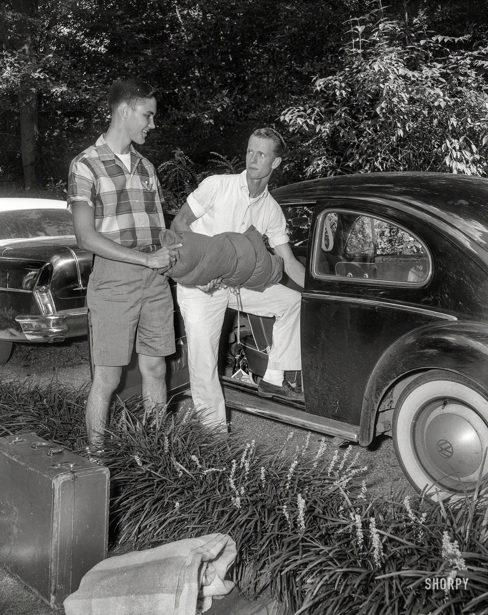 From Columbus, Georgia, circa 1957 comes this uncaptioned shot of two guys about to go somewhere. Cola? Check. Bedroll? Ditto. Daddy's Roadmaster? All gassed up. 4x5 inch acetate negative from the Shorpy News Photo Archive. View full size.
