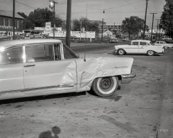 From circa 1957 Columbus, Georgia, comes this uncaptioned snap of an accident's aftermath -- a wrinkled '56 Lincoln coupe across from the Motor Mart. 4x5 inch acetate negative from the Shorpy News Photo Archive. View full size.