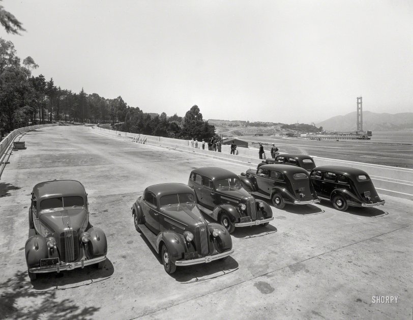 &nbsp; &nbsp; &nbsp; &nbsp; To mark the 80th anniversary of the opening of the Golden Gate Bridge, we shift into reverse to --
San Francisco, 1935. "Golden Gate Bridge under construction. Pontiacs on Presidio ramp." 8x10 negative, late of the Stanley-Blaisdell collections. View full size.
