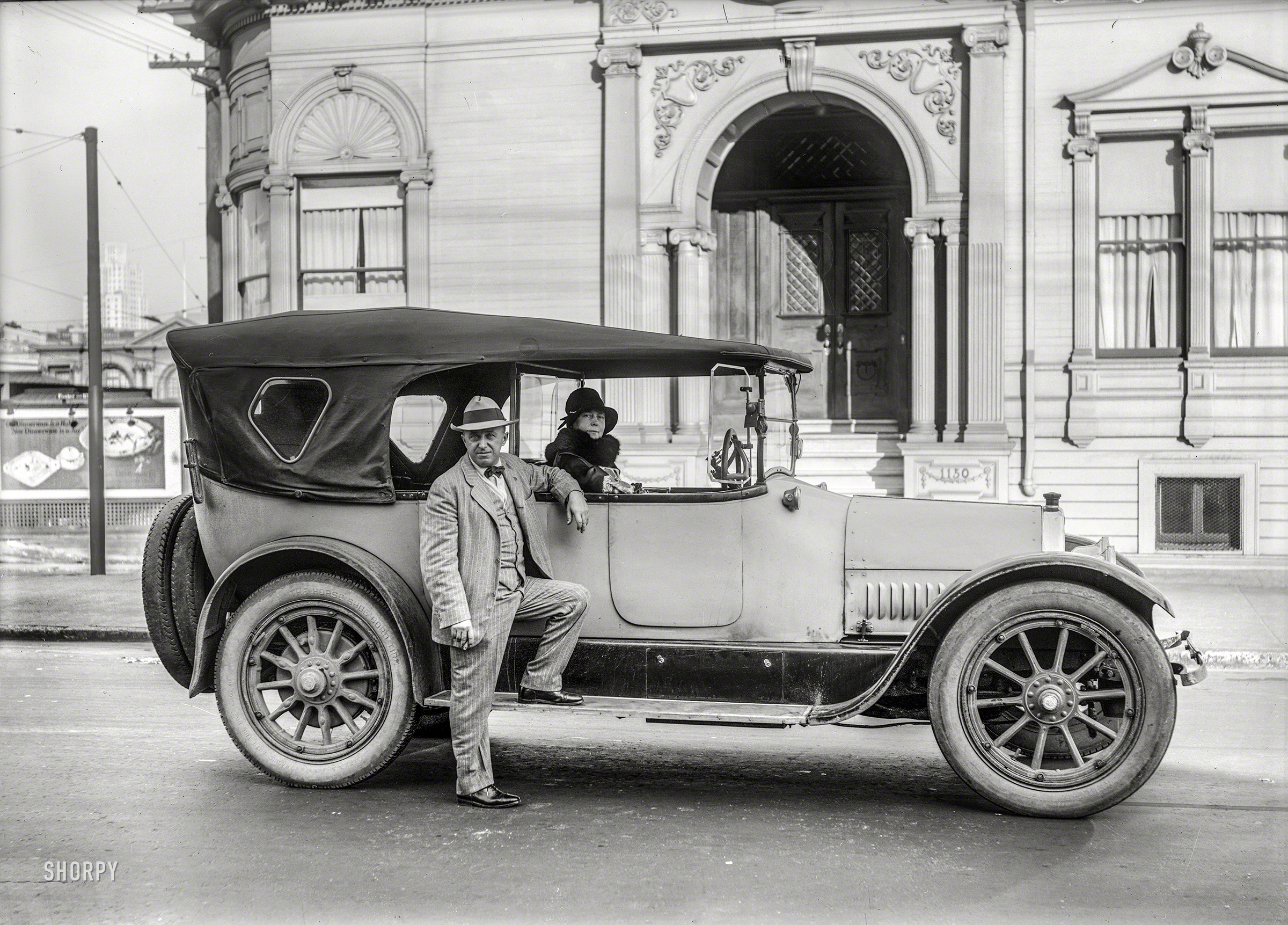San Francisco circa 1930. "1921 Cadillac touring car." A well-worn example (equipped with Horse Shoe Cord tires and a fold-away steering wheel) at the address also seen here. The subliminal message in this image is that certain things that are a habit can also be a joy. For extra credit: What things? (The answer, discerned by our sharp-eyed commenters, is: Dinnerware. Also, the high-rise in the distance is the Cathedral Apartments at 1201 California Street, completed in 1930.) 5x7 glass negative. View full size.