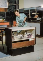 &nbsp; &nbsp; &nbsp; &nbsp; Press a button, and the dishwasher “walks” an electronic track to the dining table. Kitchen also has a robot floor cleaner and automatically adjustable sinks. By pressing buttons, Anne can prepare a complete meal without leaving the kitchen’s control panel.
March 1959. "Home economist Anne Anderson demonstrating appliances and features of RCA-Whirlpool 'Miracle Kitchen of the Future,' a display at the American National Exhibition in Moscow." Kodachrome by Bob Lerner for the Look magazine article "What the Russians Will See." View full size.