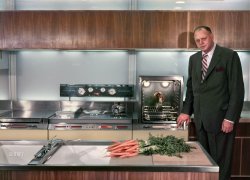 1954. "Harley Earl, General Motors Vice President of Design, in Frigidaire's 'Kitchen of Tomorrow' exhibit for the GM Motorama at the Waldorf-Astoria Hotel in New York." Flanking the Range of Tomorrow we have, on the right, the Rotisserie Oven of Next Wednesday; on the left, stowed in the down position, is an "Electronic Oven," which is what they called microwaves back in the day. Color transparency by Arthur Rothstein for Look magazine. View full size.