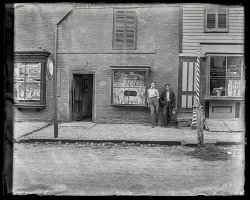 From circa 1900 in Parts Unknown comes this 4x5 glass negative of G.H. Wood Jeweler, the business, and possibly a Wood or two. View full size.
