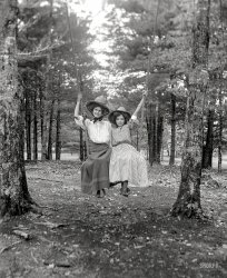 From circa 1900, somewhere in North America, comes this glass negative labeled "Lettis. Women on swing." The giant hats are especially fetching. View full size.