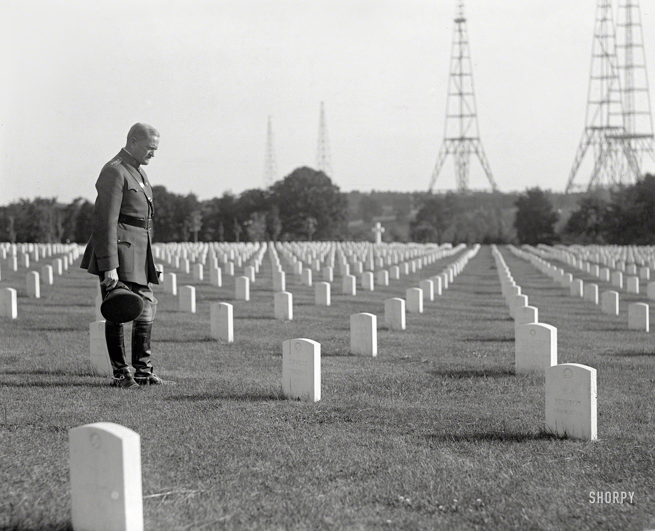 May 26, 1925. "Gen. Pershing at Arlington National Cemetery." Standing watch: masts for the Navy's wireless station, built in 1912 at Fort Myer. View full size.