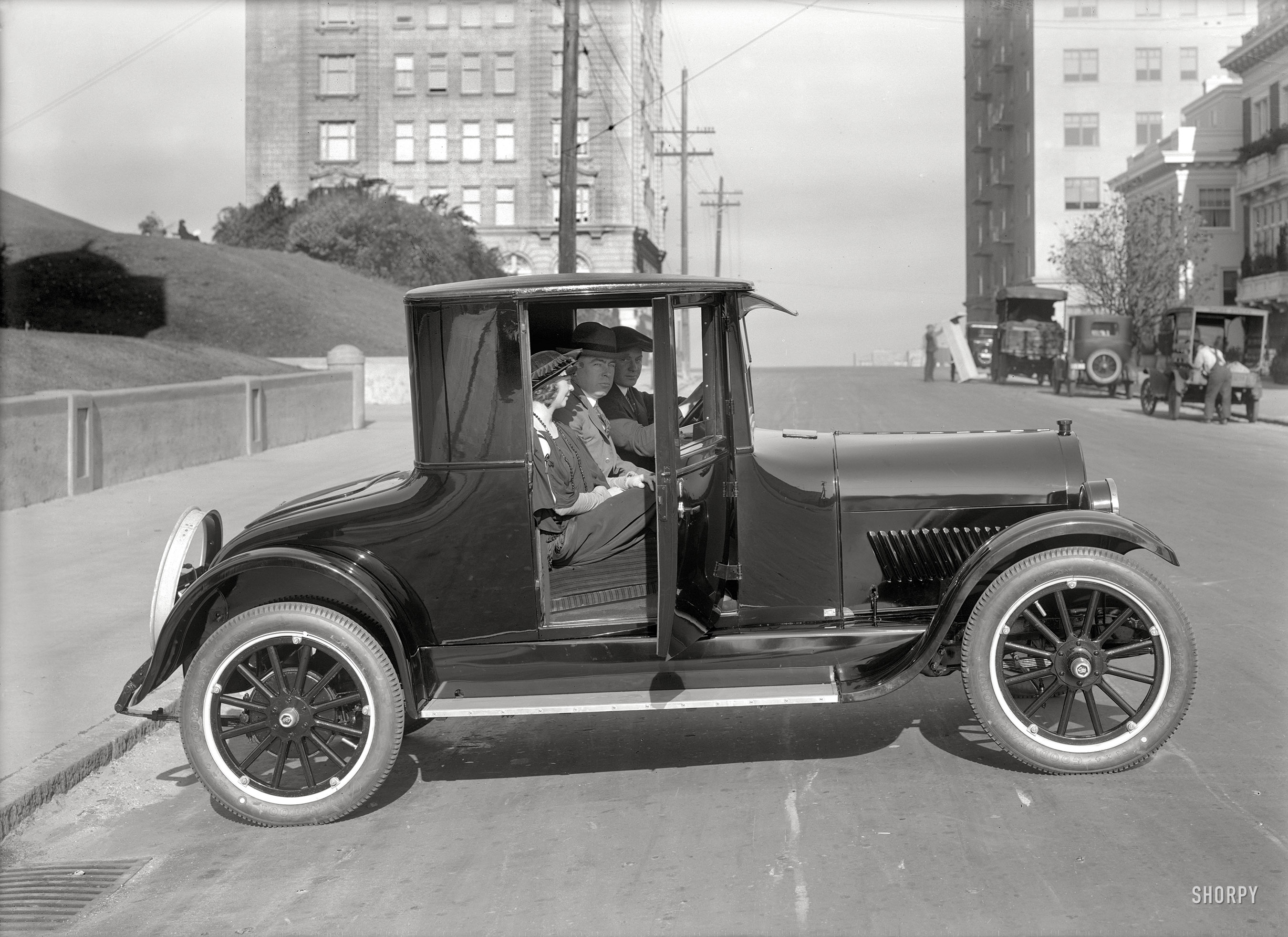 San Francisco circa 1920. "Oldsmobile coupe on Gough Street at Lafayette Park." Seats three! 5x7 glass negative by Christopher Helin. View full size.