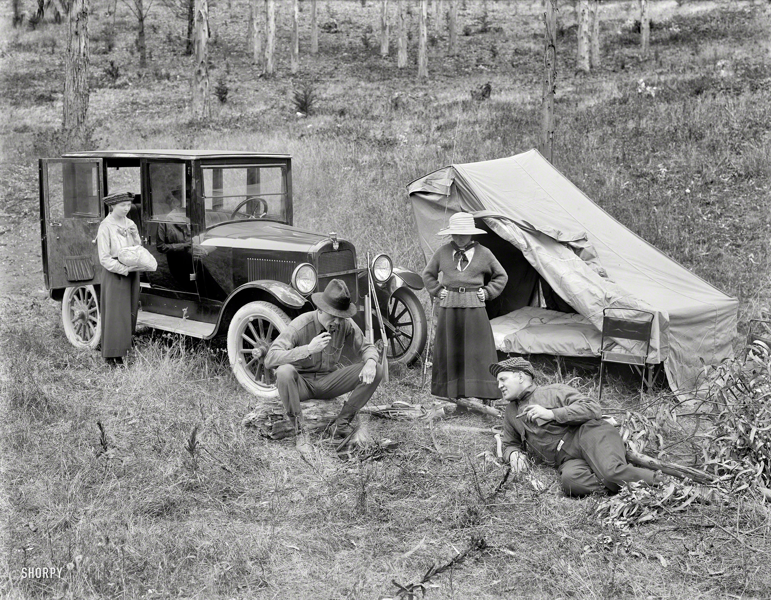 &nbsp; &nbsp; &nbsp; &nbsp; "Say, Bill, don't you think the girls did a marvelous job setting up the tent?"
California circa 1920. "Briscoe auto at campsite." We'd say it's about time to rustle up some grub. Also we call dibs on that camp chair. Now where'd we put the cocktail shaker? 8.5 x 6.5 inch glass plate by Christopher Helin. View full size.