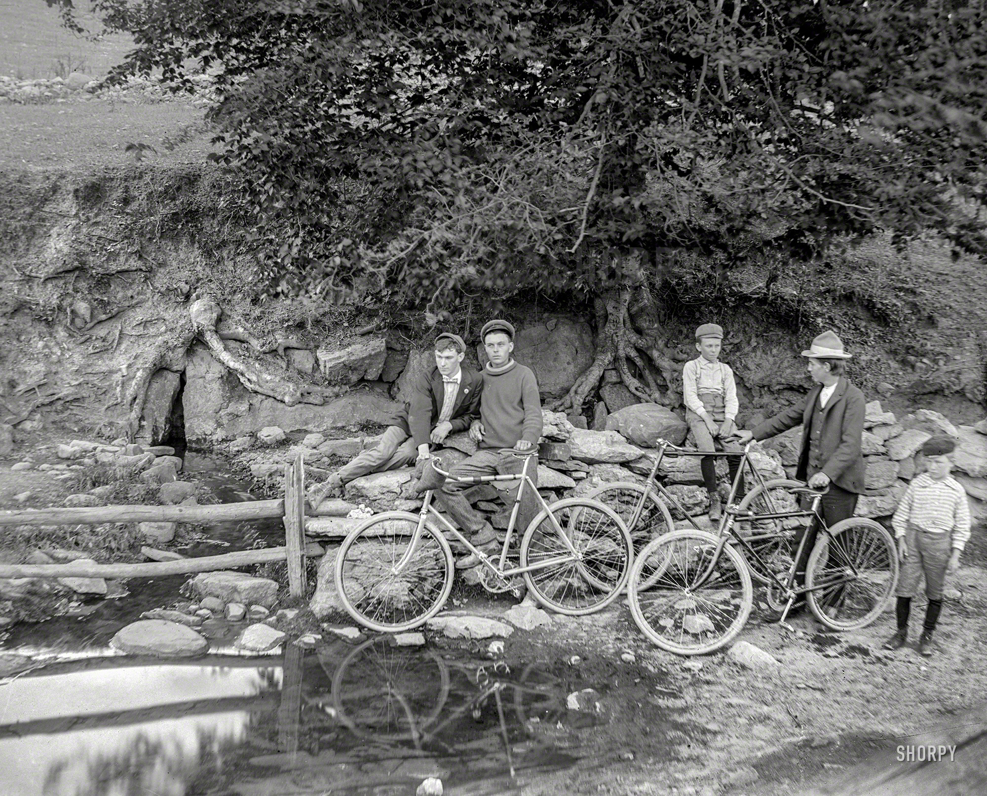 From the early 20th century, somewhere in the Northeast, comes this 4x5 inch glass negative with the caption "L.K. -- bicycles at spring." View full size.