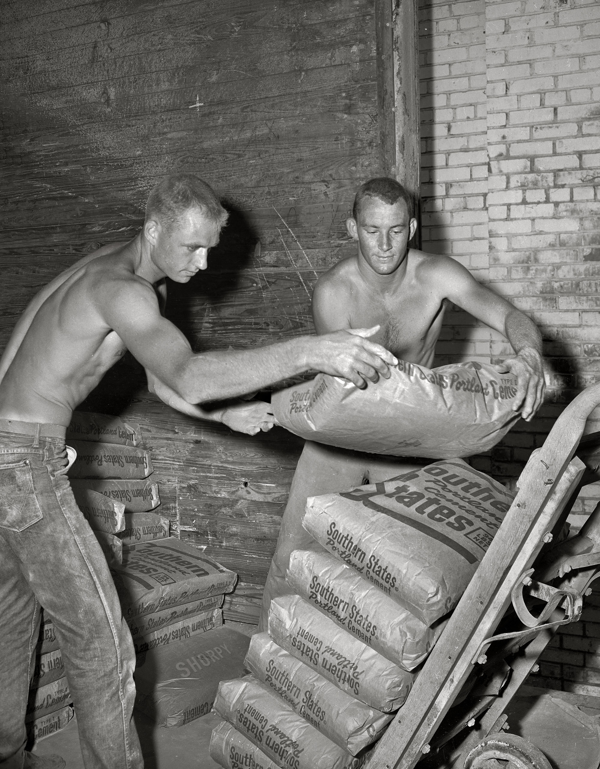 From around Columbus, Georgia, circa 1955 come the two strapping lads last seen here and here seven years ago, though they don't look a day older. Playing catch with 94-pound sacks of cement must keep you young. 4x5 inch acetate negative. View full size.