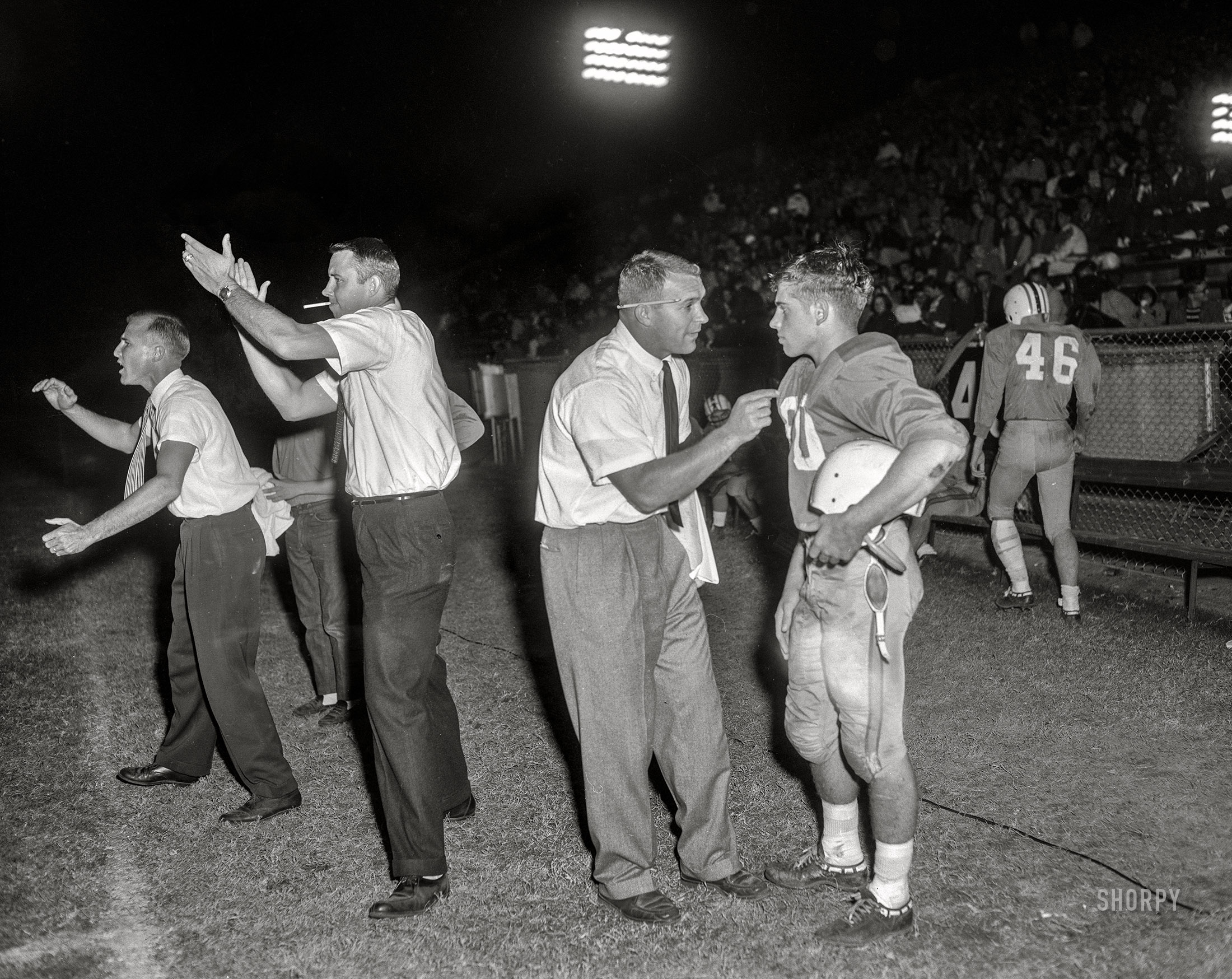 Friday Night Lights circa 1962. A high school football game from the News Photo Archive. Location: somewhere around the 40-yard line.  4x5 inch acetate negative. View full size.