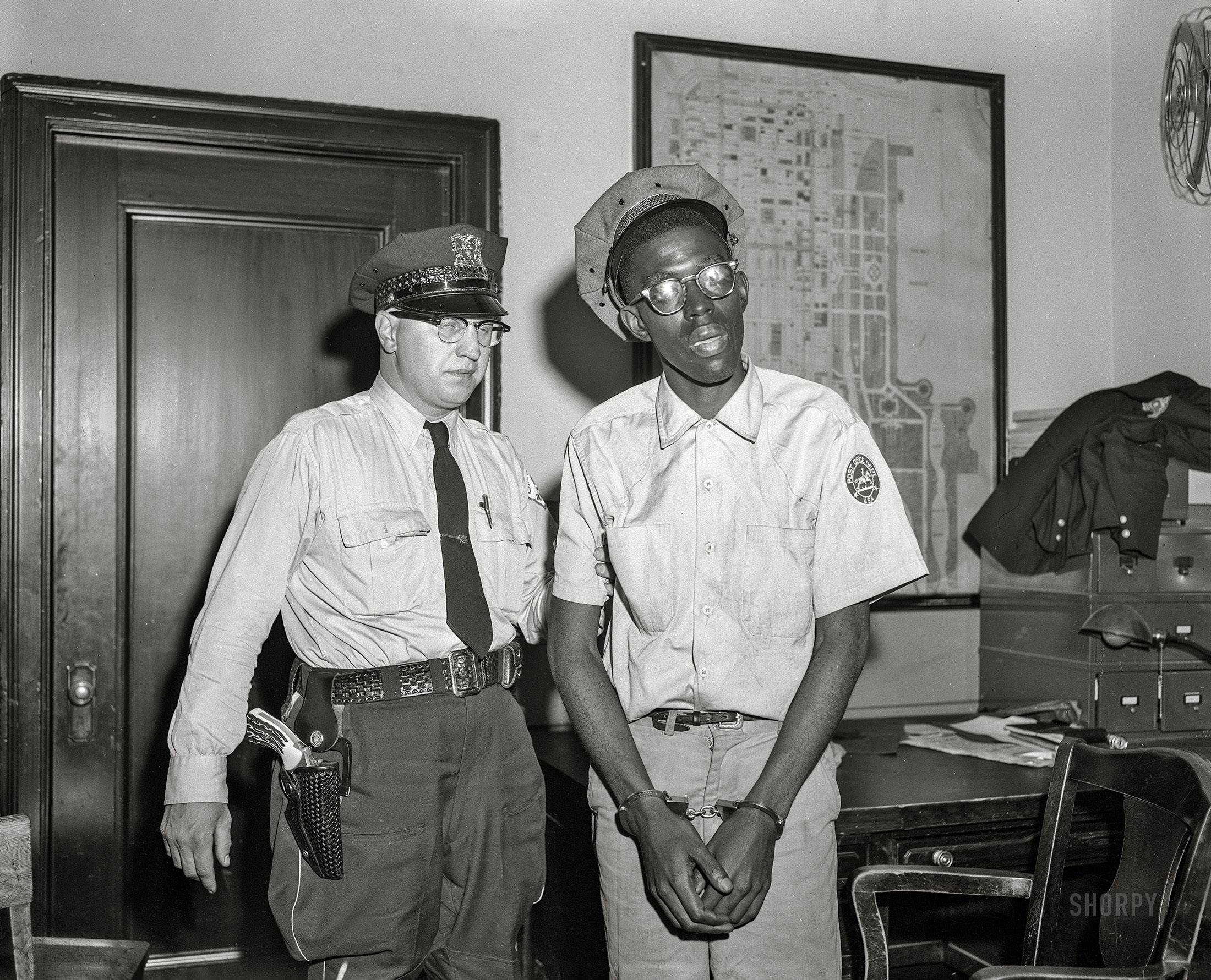 Here we are in circa 1953 Chicago with a Post Office employee under arrest. Do Not Fold, Spindle or Mutilate, or else! 4x5 acetate negative from the News Photo Archive. View full size.