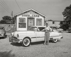 Columbus, Georgia, circa 1954. Here we are back at Rucker Oldsmobile, where the used car du jour is this pristine 1951 Pontiac Catalina. If you're ready to trade, Huarache Hank is ready to deal! 4x5 inch acetate negative from the Shorpy News Photo Archive. View full size.