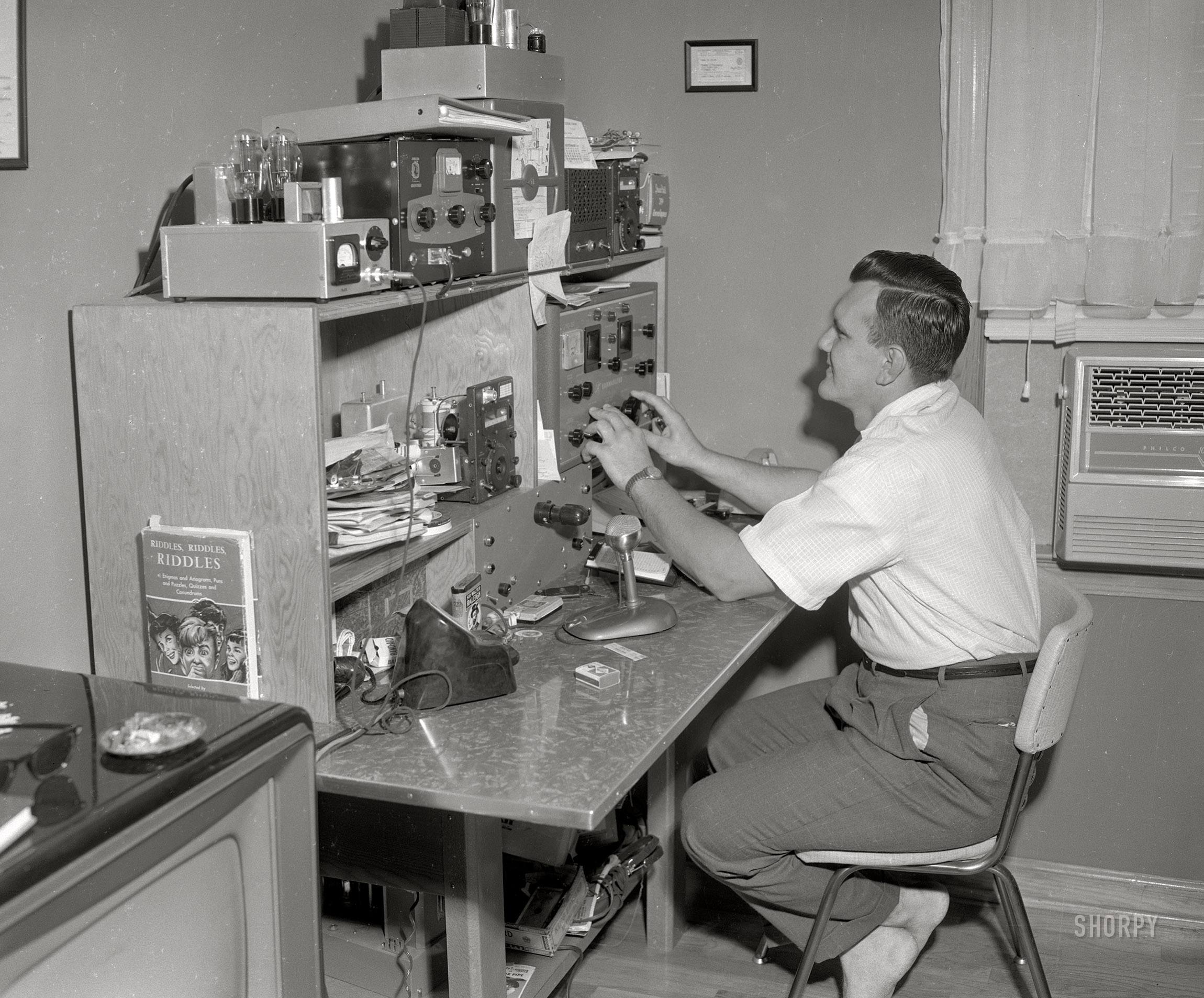 From September 1957 in Columbus, Georgia, comes this next entry from the Amateur Radio file, starring K4JNL (Eddy Kosobucki). Plus: Riddles, Riddles, RIDDLES. Air conditioning by Philco. 4x5 inch acetate negative from the Shorpy News Photo Archive. View full size.
