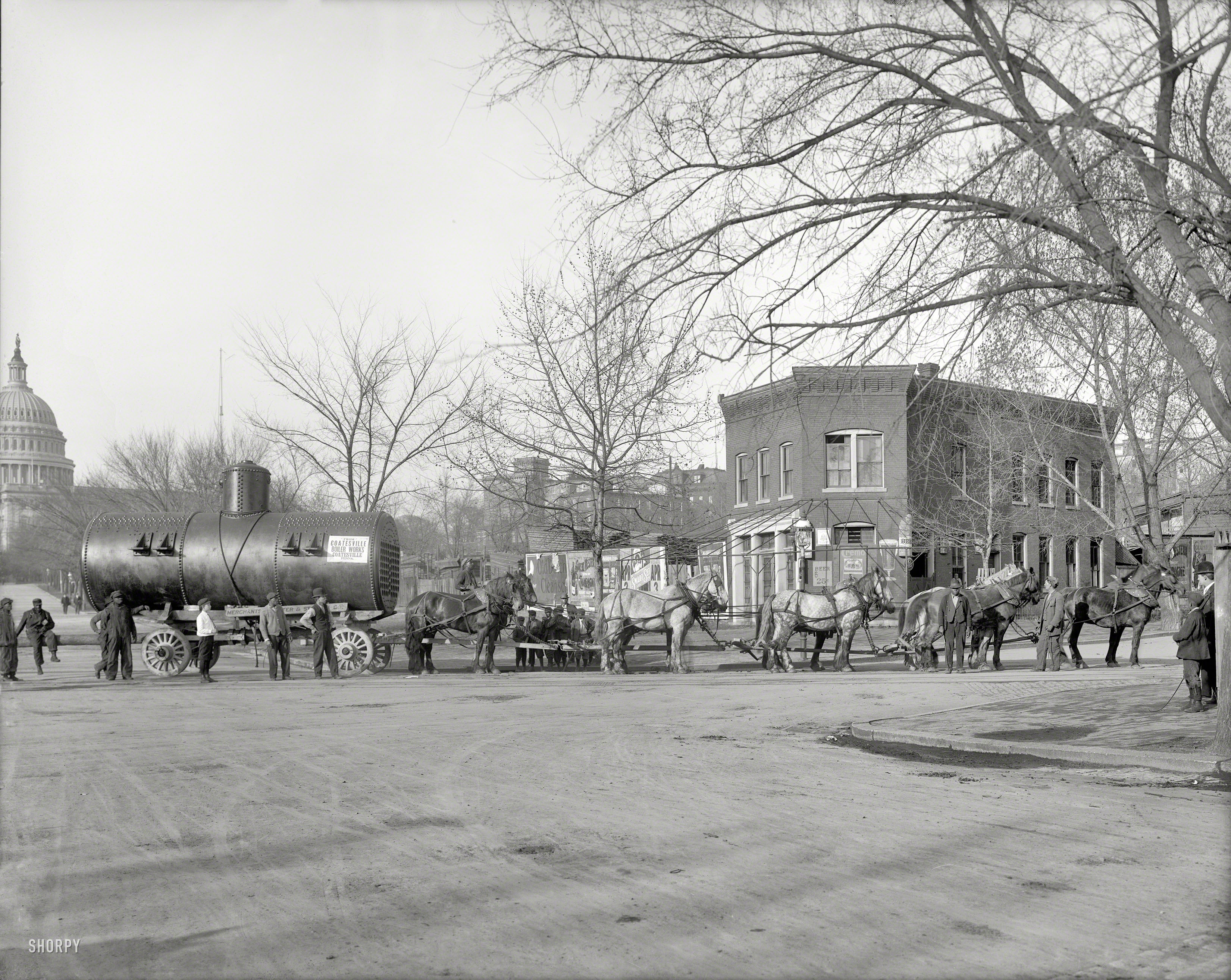 "Merchants Transfer & Storage Co., Washington, D.C." In 1911, moving a boiler on D Street within sight of the Capitol with a 12-horse team. Bonus: Many old billboards. Harris & Ewing Collection glass negative. View full size.