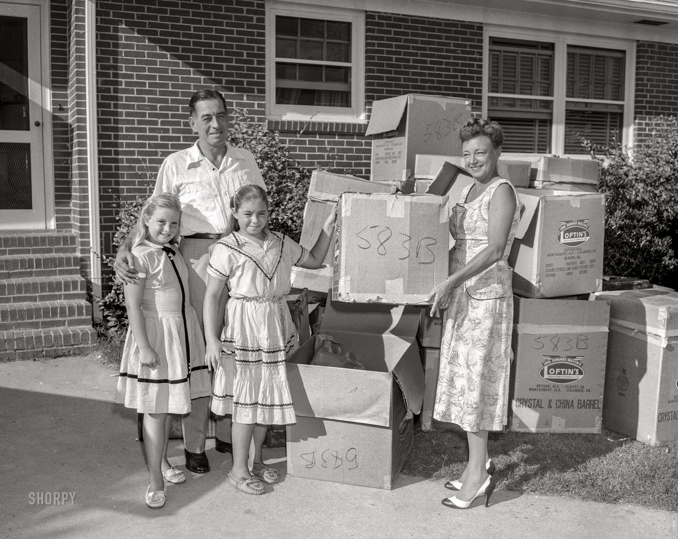From Columbus, Georgia, circa 1957 comes this News Archive photo of a happy family on moving day. The twins are unpacked, and now all they have to do is find the box Junior is in. (This post brought to you by Loftin's Transfer & Storage.) 4x5 acetate negative. View full size.