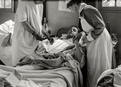 June 12, 1918. "Dressing the wound. American Military Hospital No. 1 at Neuilly, France (Dr. Johnson)." 5x7 inch dry plate glass negative by Lewis Wickes Hine for the American National Red Cross. View full size.