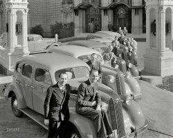 "1936 Pontiacs and salesmen at the Mark Hopkins Hotel, San Francisco." Lined up at the Bottom of the Mark. 8x10 inch Kodak safety negative. View full size.
Third Car is a 1935 ModelThe third car with the headlights attached to fenders and different insignia is a 1935 model.  Could this photo have been taken in late 1935 when the 1936 models were introduced?
Fender sittingDon't try that on your new car today, you'll wind up with dents.
Car number 3Is a '35. Guessing that #4 is your base model with no straight 8 engine or emblem, and painted as opposed to chrome grille. 
Some are new, some are notVitojo, the two that have the headlights mounted to the fenders are 1935 models; the rest are '36 models.  Notice also that on the '35 models, the side elements of the grilles contain vertical bars, instead of the horizontal bars seen on the '36 models. 
Cool hood ornamentThat Pontiac hood ornament; the Indian w/the ring around it was very fragile --I wonder how many were intact a year later
Different PontiacsThe third car from the front is a 1935 Pontiac. It is very similar to the '36s. The '35 introduced the first "turret top". The most noticable difference was the front door hinge location, which was moved from the front to the back.
Re: Third car from the front or the backI think the car with the headlights not attached to the nose is a 1935 model while the others are 1936. Someone near my house had a 1936 Pontiac similar to these for sale last year. I would drive by and think how great it would be to own something like that, but boy you would have to know a lot about old cars (and where to get parts!) to maintain something like that.
What no tailfins?I was born just as cars were starting to sprout tailfins, but if asked to draw a car today, one representing all, this is the silhouette that comes most often to mind.  A lasting design statement.
I love those grillesI do, I do, I do.
&quot;The wheels will fall off&quot;, as Mom would sayMy father, a genius certified by the U.S. Army, loved Pontiacs, even more than the Cadillacs, Studebakers, and Jaguars he'd owned. Perhaps it was the adventure aspect--searching for mechanics in the most remote scenic byways of pre-interstate America.  All of us kids remember vividly our made-up games of collecting bottlecaps to while away hours as Dad and the Sinclair greasemonkey reattached the wheelhub of our '56 Chieftan, our '59 Starfire, our '63 GTO or our '66 Bonneville so we could get on with our vacation.  It was no wonder that whenever Dad came home grinning with the new one, Mom would say simply, "The wheels will fall off".
Heading home two weeks ago, the turn lane onto my street was blocked by a police cruiser.  "An accident", I thought.  But no, the officer was merely protectively blocking off traffic for a man in one of the last Pontiacs built, its right front wheel, hub and all, detached and lying over on its side nearby.
Dad finally admitted at age 80 that Mom was smarter.
Nevertheless, one of my fondest memories is as a child of three, driving my uncle's hot pink '56 Pontiac down the brick streets of Amarillo, Texas, with my mother and aunt in the back seat asking, "Do you think this is a good idea?"  Thank goodness the wheel didn't fall off.  
Pontiac StripesThose long stainless stripes that sweep down over the front of the hood decorated Pontiacs in one form or another, every year for 20 years and became more or less a Pontiac trademark thru' 1955 or '56, second only the the Indian Chief. 
Third Car InterlopersThe two Pontiacs with the headlights not attached to the nose are 1935 models.  The other Pontiacs, with the lights attached just behind the grille, are from 1936.  The 1935 models were the first with the "Silver Streak" running down the hood.
The two cars in the background are 1935 Fords.
Third car from the front or the backHeadlamps not attached to the nose and different insignia. What would be the difference between these and the others? Very stylish cars indeed.
The Silver Streak PontiacsThe two Pontiacs with headlights attached to the fenders instead of the nose are 1935 model year cars. Also note that the third from the back has turn signals on the fenders, this was called the "Improved" model and it also featured a more artistic hood ornament. The hood ornament on the third from the front is the normal 1935 version.
[I believe those are parking lights, not turn signals. -tterrace]
Silver StreakThis was the second year for the brand identifying metal band down the hood and on the trunks of some models and would stay around through 1956.
FascinatingNearly 20 years later my grandfather, father and two uncles would strike exactly the same pose outside of the family business with their company Buicks (Dad's was a cherry red convertible).
(The Gallery, Cars, Trucks, Buses, San Francisco)