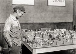 July 1918. "Alex, a 14-year-old working boy in St. Etienne, France, was found intently studying the playground model at the Children's Welfare Exhibit of the American Red Cross. He has been working since 11 years of age, and said: 'On account of the high cost of living, I now get four and a half francs a day'." 5x7 inch glass negative by Lewis Wickes Hine for the American Red Cross. View full size.