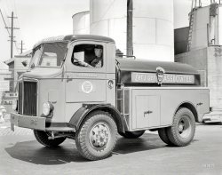 August 9, 1935. San Francisco. "GMC truck -- Associated Oil fuel tanker." Short but sweet. 8x10 inch Kodak nitrate negative. View full size.
Let&#039;s Get AssociatedFrom our collection, a time- and tape-ravaged Associated Oil road map, probably used on my folks' honeymoon trip.
And they said --we couldn't make the shortest truck in the world.
Short in two dimensionsFor years I wondered why old tank bodies rode so low. Recently it occurred to me that the tanks probably weren't baffled. A high center of gravity is especially dangerous when your liquid load makes waves. Can any truck experts tell me when baffles were introduced?
The guy behind the wheellooks like the poster boy for the guy in the "Let's Get Associated" logo!
All the latestNeat turn indicator devise mounted on the corner post.
How times have changedI must say, that is NOT how my delivery man was dressed the last time I had a tank of oil delivered.
If &quot;What&#039;s Your Sign?&quot; didn&#039;t work..."Let's Get Associated". That was my pick-up line in college.
(The Gallery, Cars, Trucks, Buses, San Francisco)