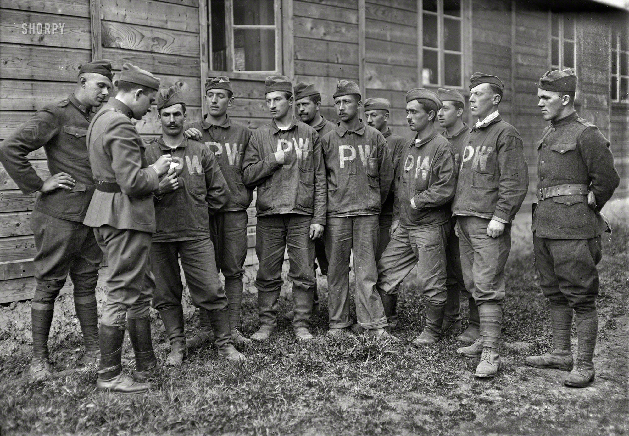 October 30, 1918. "Base Hospital No. 7 at Tours, France. American Red Cross Chaplain the Rev. F.M. Eliot taking the home addresses of interned German prisoners, so that their families may be notified that they are well. They showed much appreciation of favors." 5x7 glass negative by Lewis Hine. View full size.