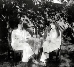 From somewhere in England circa 1925 comes this 4x5 glass negative of two libated and liberated ladies lounging in their pyjamas by the garden wall. Shorpy lifts his glass  in a toast to them, to you, and to the New Year! View full size.