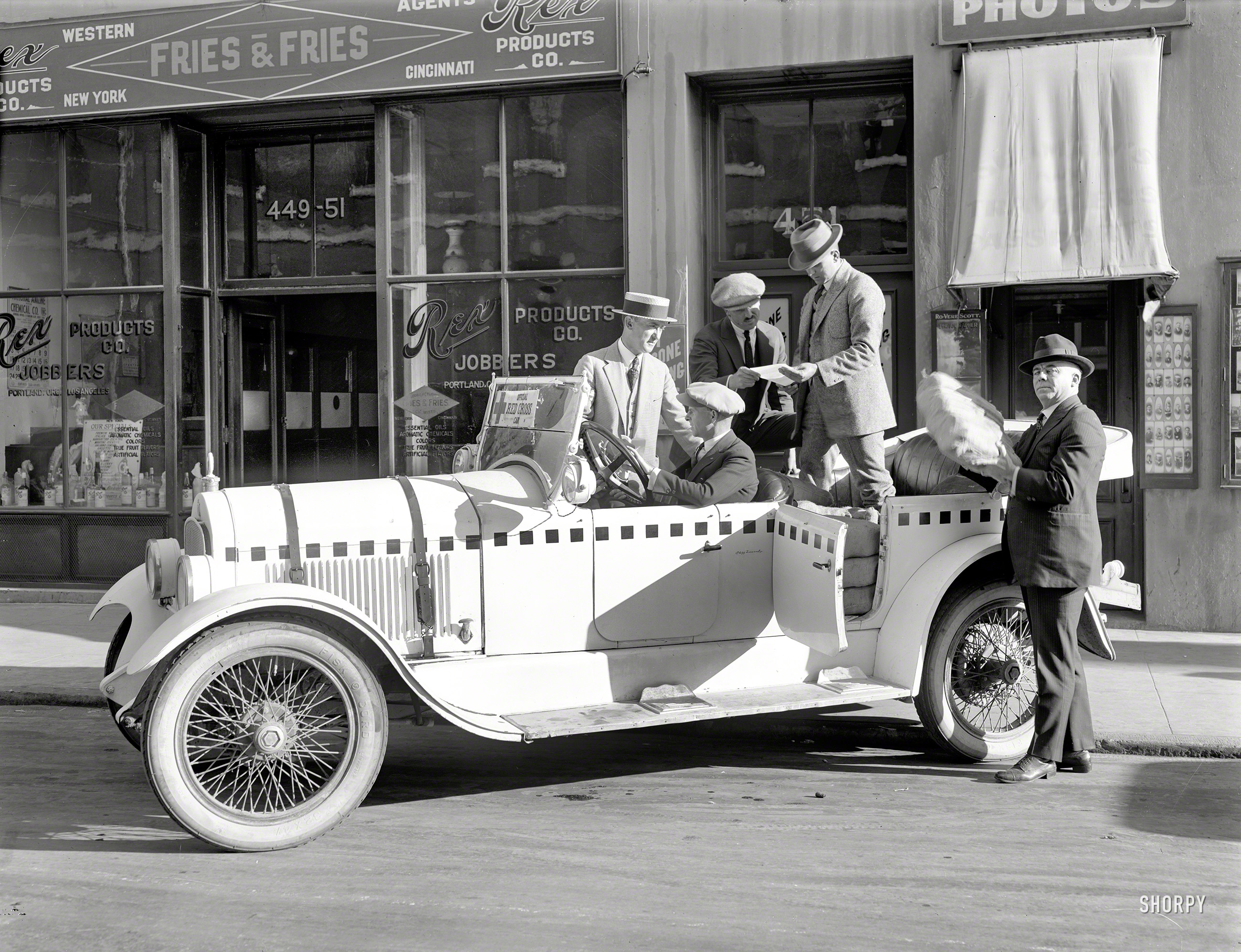 San Francisco, 1922. "Official Red Cross car." Being loaded with sacks of something outside the premises of Rex Products Co., Jobbers. Also note the studio of Rovere Scott, Photographer. 6½ x 8½ glass negative. View full size.