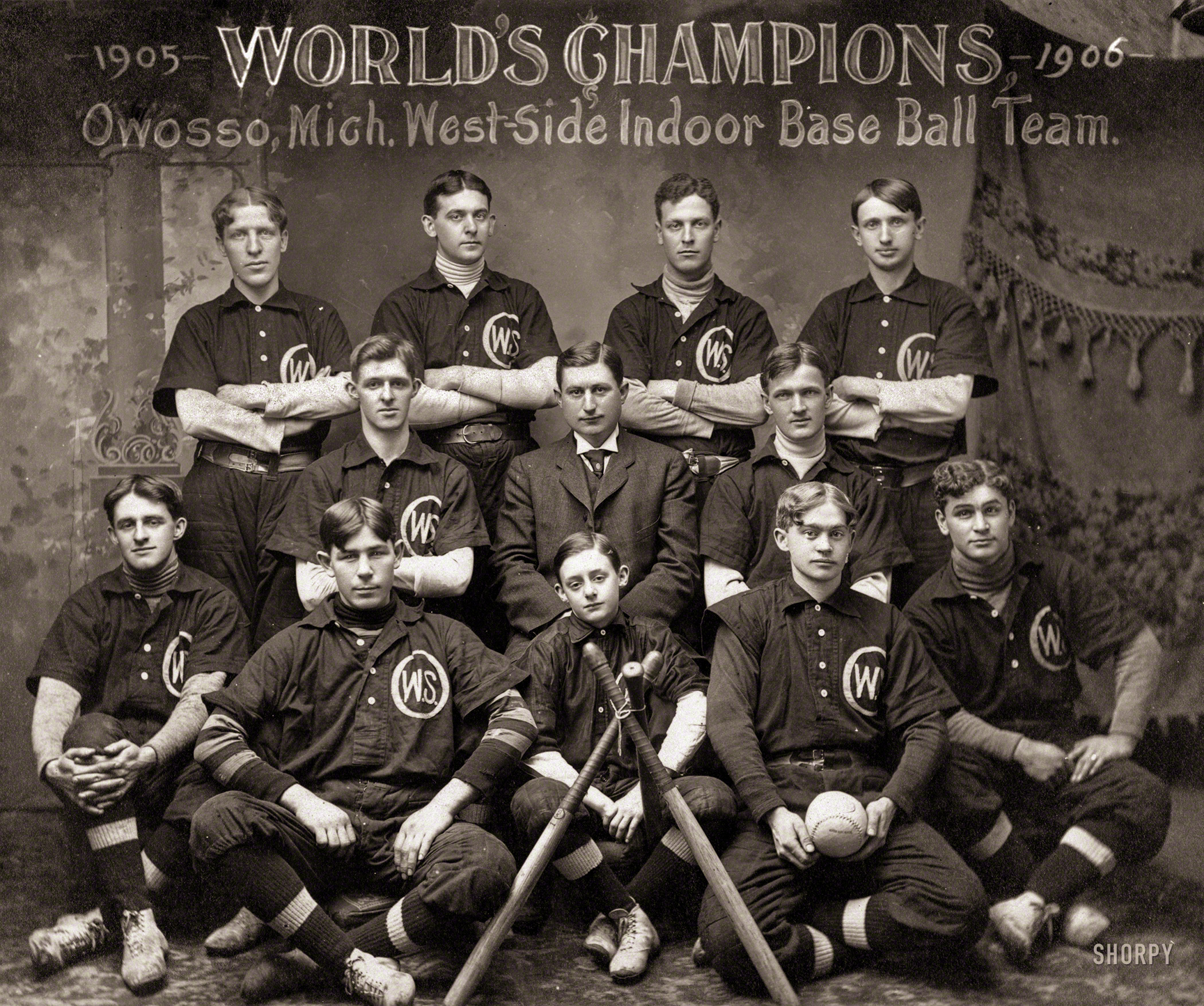 &nbsp; &nbsp; &nbsp; &nbsp; "Indoor baseball, both from a spectacular point of view and from the benefit and pleasure it gives participants, is in every way worthy to take a high place among the Winter sports."
-- New York Times, Nov. 26, 1900
"World's Champions, 1905-1906, Owosso, Mich., West-Side Indoor Base Ball Team." Indoor Baseball, said to have been invented in Chicago in 1887, eventually moved outside, where it was renamed softball. The 1919 Encyclopedia Americana entry for Indoor Baseball specifies a hall at least 40 by 50 feet in size for play. Two outfielders could be "dispensed", leaving seven men on a team. The ball could be as big as 17¼ inches around. (Baseball-Reference.com) View full size.