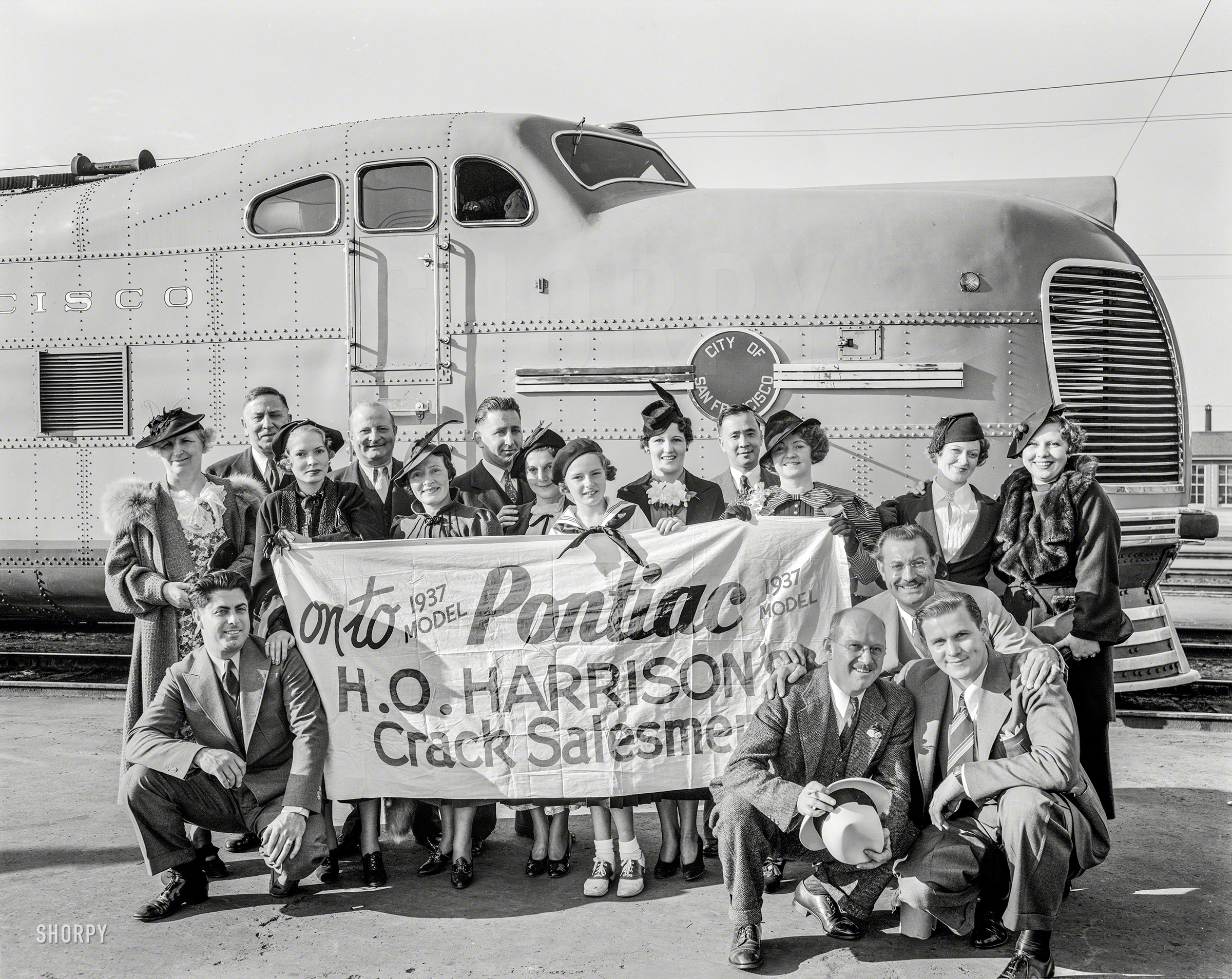 Oct. 8, 1936. "H.O. Harrison Pontiac -- 'crack salesmen' and wives 'Going East' on streamliner City of San Francisco." 8x10 acetate negative. View full size.