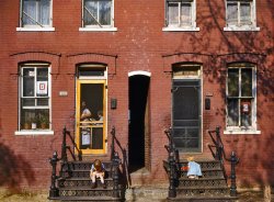 Washington, D.C., 1942. "Children on rowhouse steps, corner of N and Union Streets S.W." Note service stars in the windows and the curious narrow passage between houses. Kodachrome transparency by Louise Rosskam. View full size.