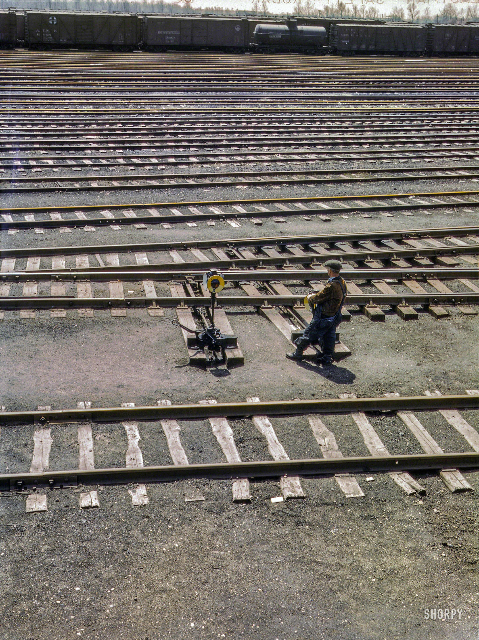 April 1943. "Switchman throwing a switch at the Chicago & North Western RR's Proviso Yard, Chicago, Ill." 4x5 inch Kodachrome transparency by Jack Delano for the Office of War Information. View full size.