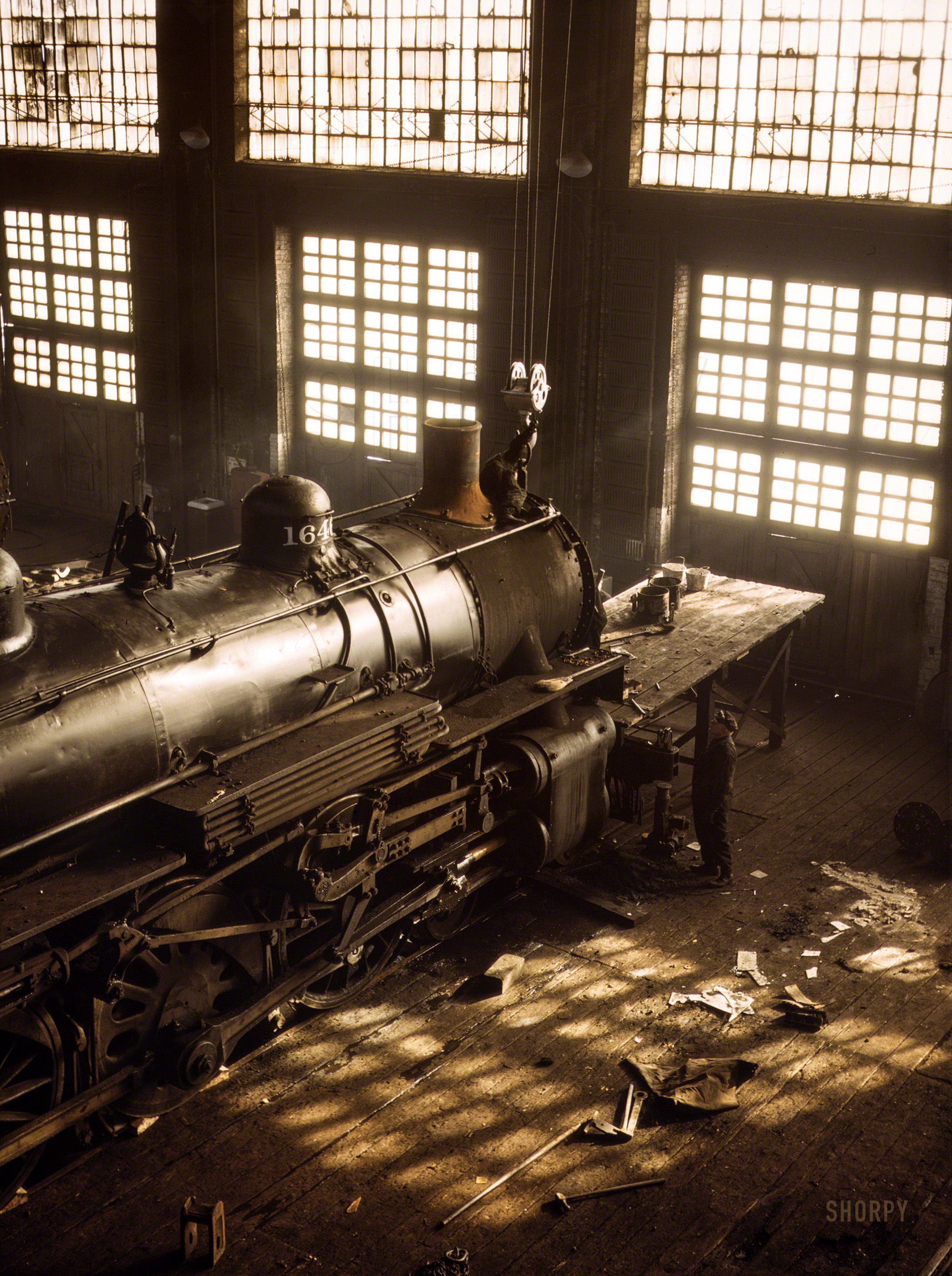 &nbsp; &nbsp; &nbsp; &nbsp; Back to the days of the blacksmith: The only tools seen here are two hammers, a wrench and a broom.
December 1942. "Working on a locomotive at the 40th Street Shops, Chicago & North Western R.R." Kodachrome transparency by Jack Delano. View full size.