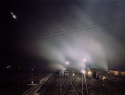 March 1943. "Santa Fe R.R. yard at night, Kansas City, Kansas." Note the light trails made by the yard workers' torches in this time exposure, as well as a phantom number (3167, at right) on a train that paused in front of the camera. 4x5 inch Kodachrome transparency by Jack Delano. View full size.
