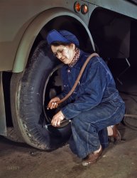 February 1943. Milwaukee, Wisconsin. "War production workers at the Heil Company making gasoline tank trailers for the U.S. Army Air Corps. Mrs. Angeline Kwint, age 45, an ex-housewife, checking the tires of trailers. Her husband and son are in the U.S. Army." Kodachrome transparency by Howard Hollem for the Office of War Information. View full size.
