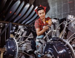 June 1942. "Inspecting a Cyclone airplane motor at North American Aviation in Long Beach, Calif." Kodachrome transparency by Alfred Palmer. View full size.
Rosie the riveter?Nope.  This is her sister.
RH - LHThe motors are marked "833 LH" and "333 RH" which I'm certain means they are bound for the same aircraft, left and right handed, but can someone more knowledgeable inform me - would they have been counter-rotating, that is one a clockwise and one a counter-clockwise rotating engine? Are they mirror-images in terms of exhaust placement, etc?
One Way OnlyAll of the Cyclones turn the same way, so there isn't a left handed engine. However the accessories are not identical. One might have a hydraulic pump where the other has a generator etc, so there IS a difference in RH and LH engines on the same airplane.
Counter Rotating Engines on AircraftSeveral aircraft had counter rotating engines.  The best known was probably the P-38 Lightning.  The idea was to reduce torque steer if an engine failed during take off.
Oppostie-Rotation ReduxA little more than torque involved, getting into the interaction of prop vortices and wings.
In any case, opposite rotation engines are the exception rather than the rule, and all of the US radial engines turned the same direction. Interchangeability and commonality was deemed far more important than any gains from an LR engine.
The P-38 is one of the few widely produced exceptions (and was offered to the RAF in a version with both engines turning the same direction)
P 38Not so much eliminating torque steer, but more making the effects on either engine the same, so no "critical engine".  The other big advantage of counter-rotating engines was a lack of torque effects with power changes in combat.  The P38 was jet like in this regard in being free of rolling or slewing effects with power changes.  A very advanced airplane in spite of development troubles; in some ways the P38 was the F22 of its age (and similarly expensive).
(The Gallery, Kodachromes, Alfred Palmer, Aviation, WW2)