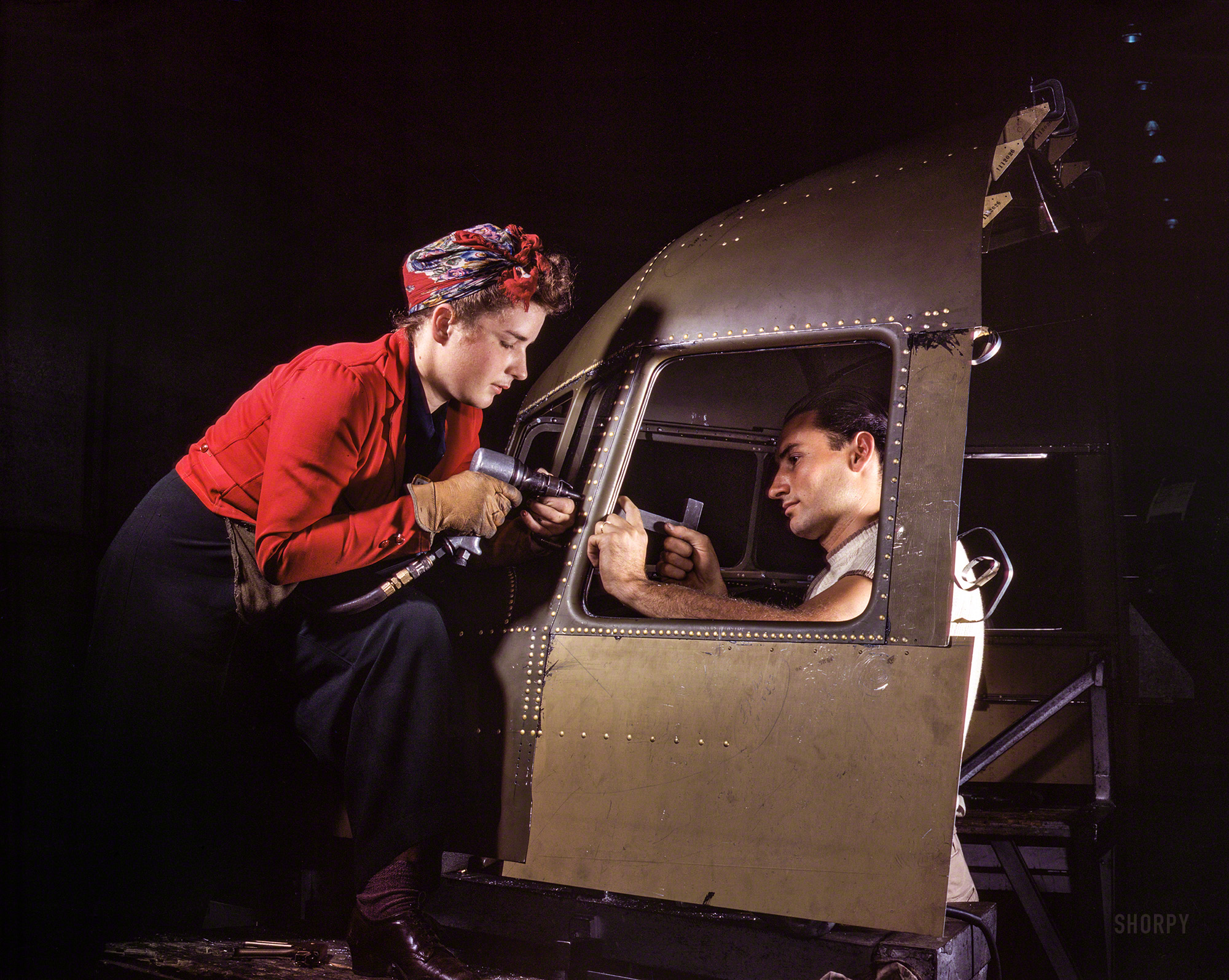 October 1942. "Men and women make efficient operating teams on riveting and other jobs at the Douglas Aircraft plant, Long Beach, Calif. Most important of the many types of aircraft made at this plant are the B-17F 'Flying Fortress' heavy bomber, the A-20 'Havoc' assault bomber and the C-47 heavy transport plane shown here for the carrying of troops and cargo." 4x5 inch Kodachrome transparency by Alfred Palmer for the Office of War Information. View full size.